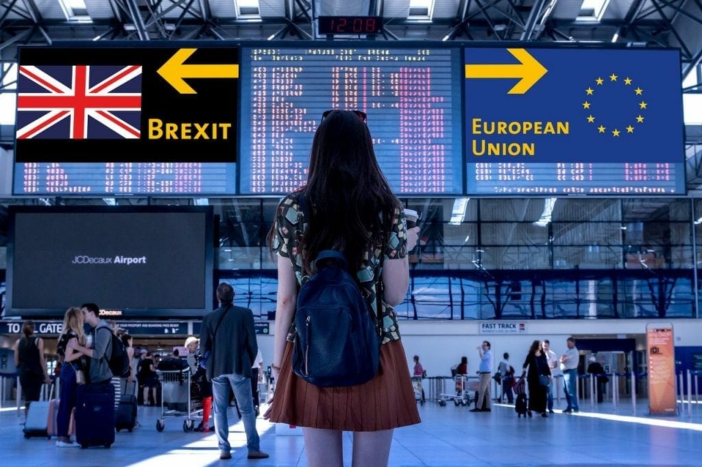 Woman looking at sign pointing to both EU and Brexit