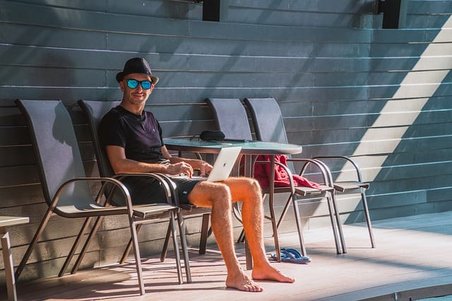 A digital nomad working by the pool